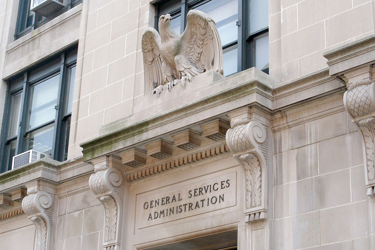 Angled view of an ornate doorway with a stone eagle statue above it and General Services Administration engraved near it