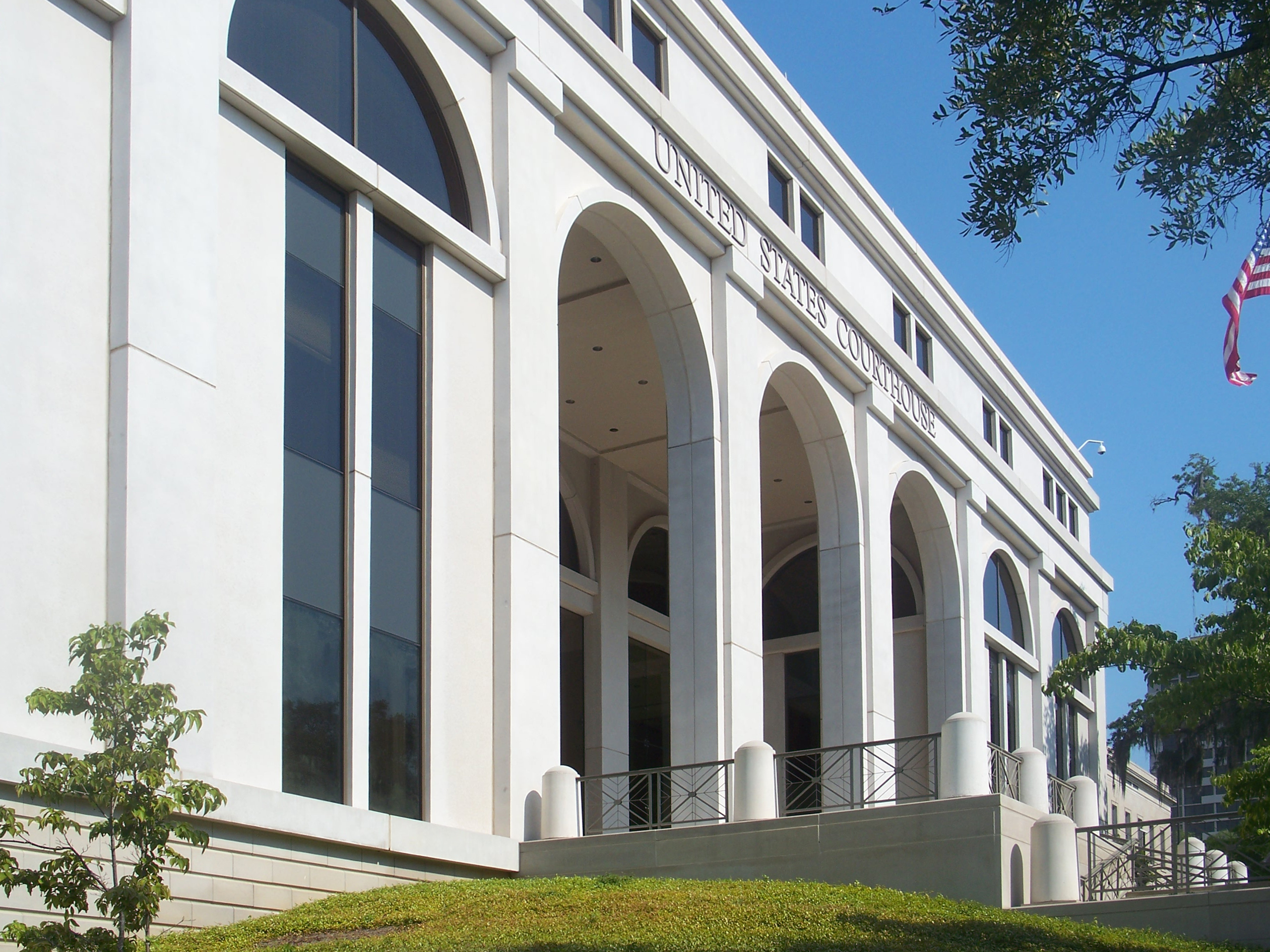 Exterior of the Tallahassee United States Courthouse Annex, white building with several arche