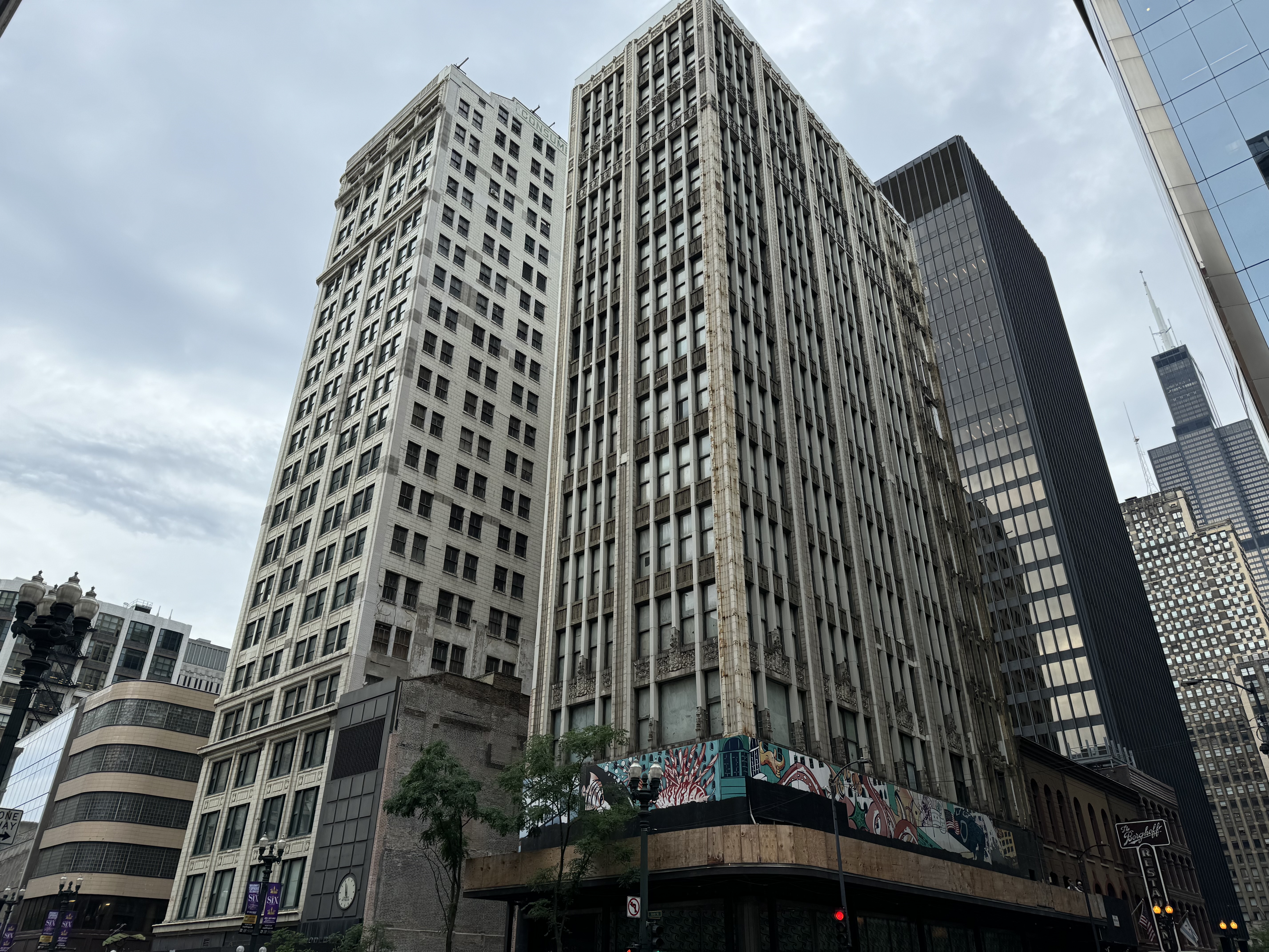 Image of two multi-story brick buildings located at 202 and 220 S. State Street Chicago with other skyscrapers in background..