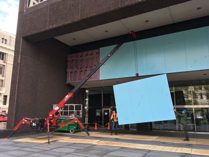 Crane lifting panels into place