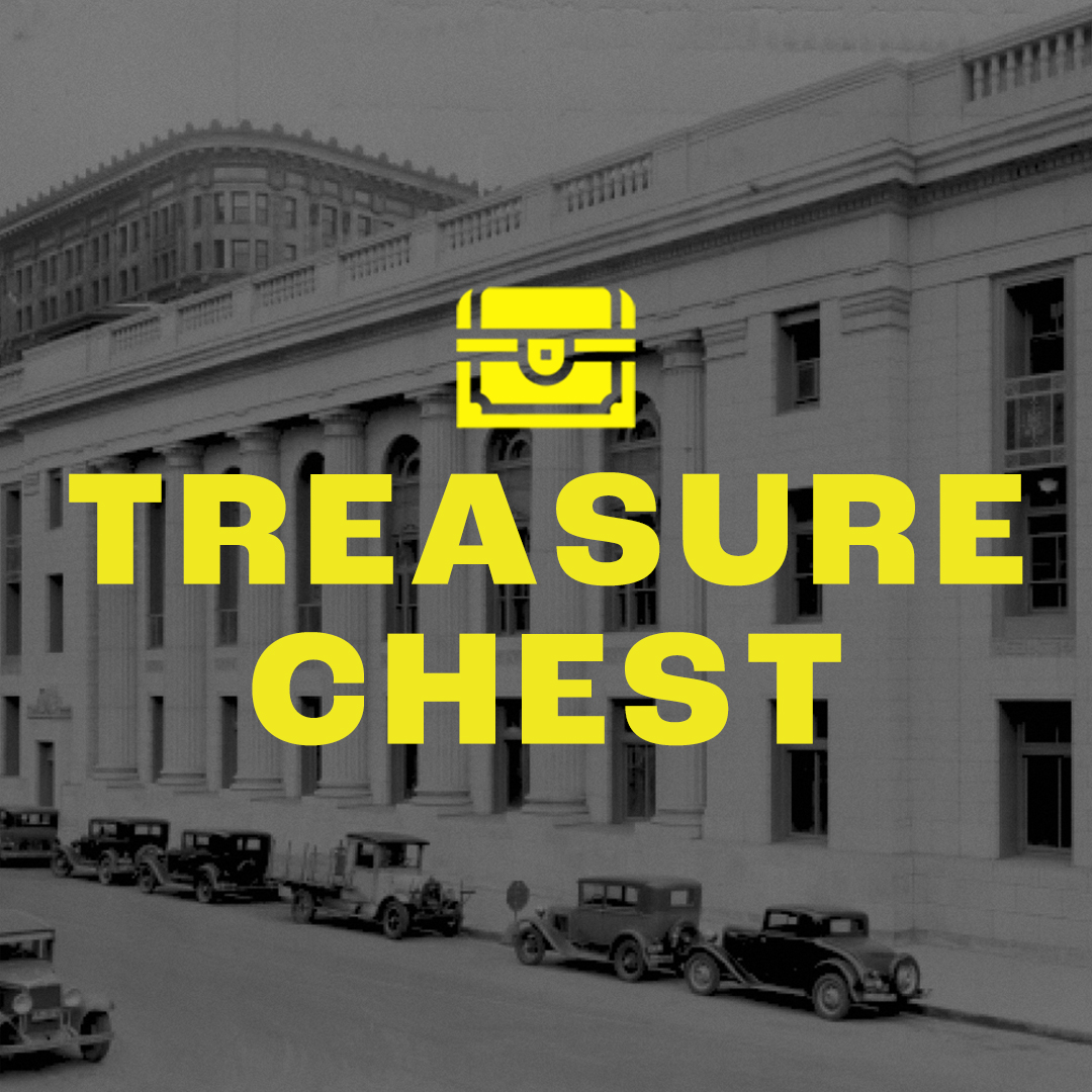 Black and white building with yellow text and treasure chest icon on top.