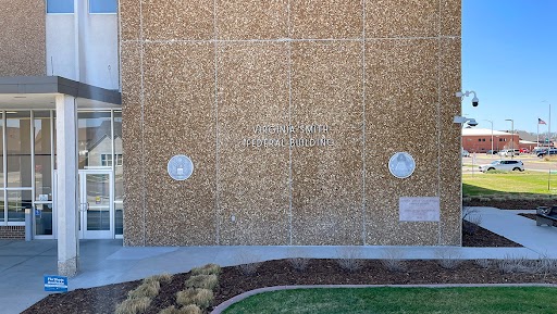 View of the words Virginia Smith Federal Building mounted on the side of a building&#039;s wall.