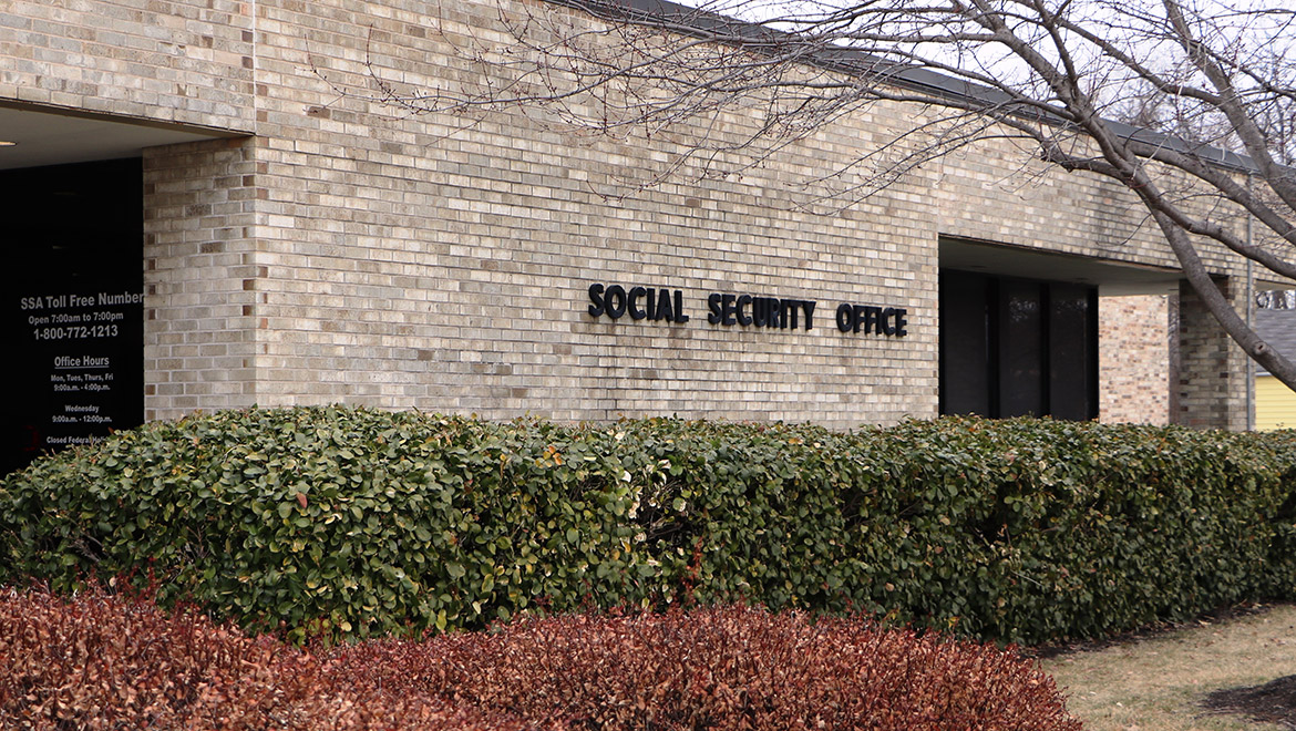 Facade of a yellow brick building marked with Social Security Office on the exterior, in Kansas City, KS