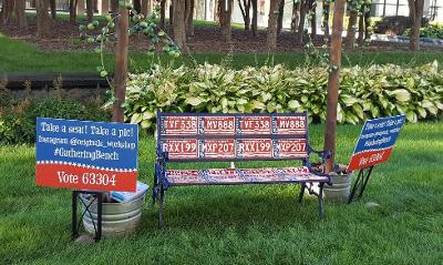 An artwork bench made of license plates and signs