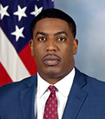 Portrait of Raphael Johnson, who wears a dark blue jacket, white shirt, and maroon tie