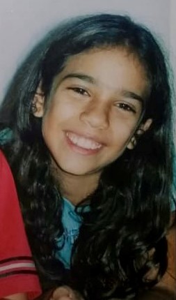 Photo of stephanie ramirez as a school aged child. she is smiling