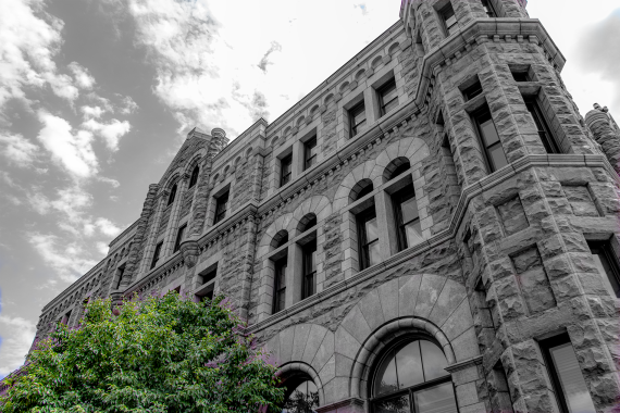 Exterior shot of the Sioux Falls Courthouse in Black and White with color for the tree only