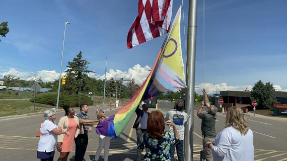 Region 8 employees raise the Intersex-inclusive Progress Pride flag over the Denver Federal Center.