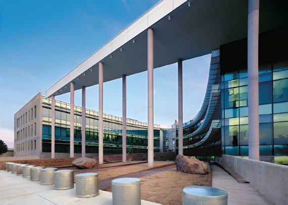 Exterior view of the Oklahoma City Federal Building from ground level showing an open area covered by a triangular overhang with columns.