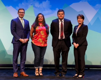 GSA Energy and Sustainability Team on stage with colorful background