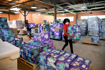 Woman carrying boxes of diapers