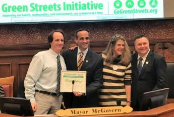 Cambridge Mayor Marc McGovern presenting award to GSA employees for Green Streets Initiative