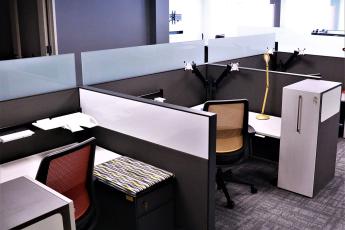 New office furniture in an office setting with cubicles
