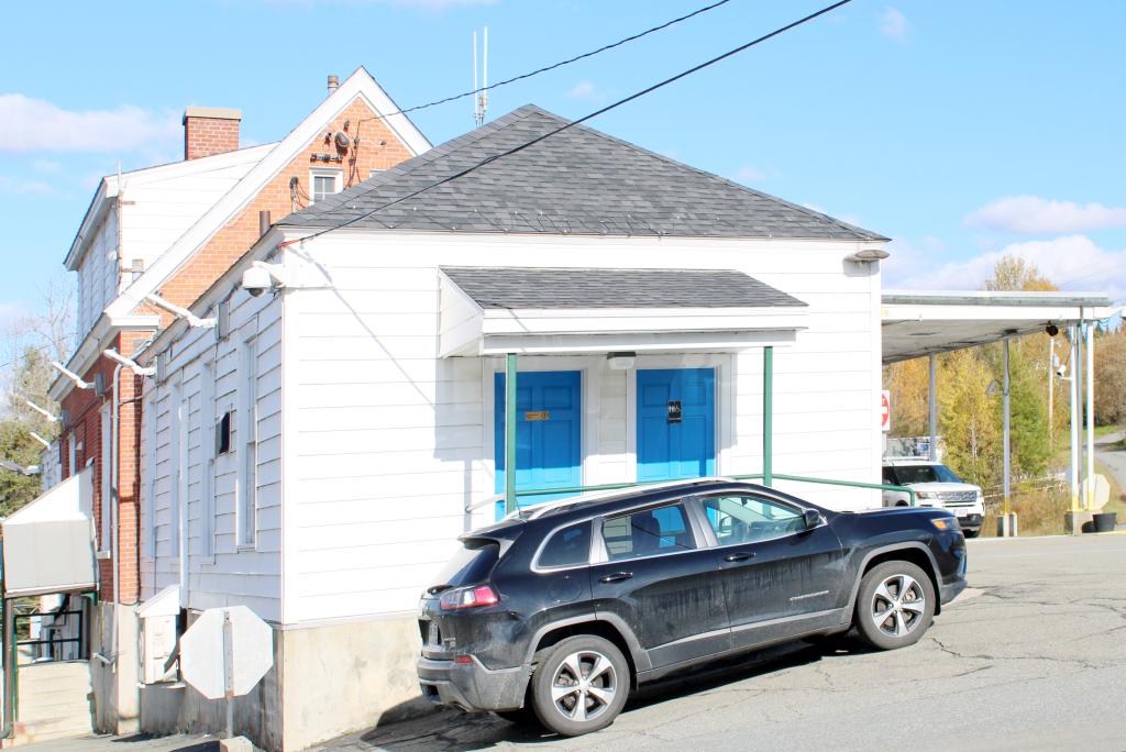 a black car parked on the side of the building