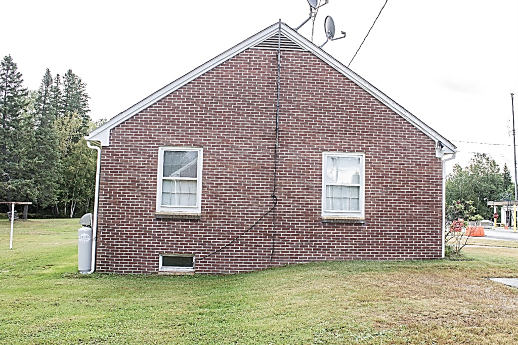 one story brick building with two windows