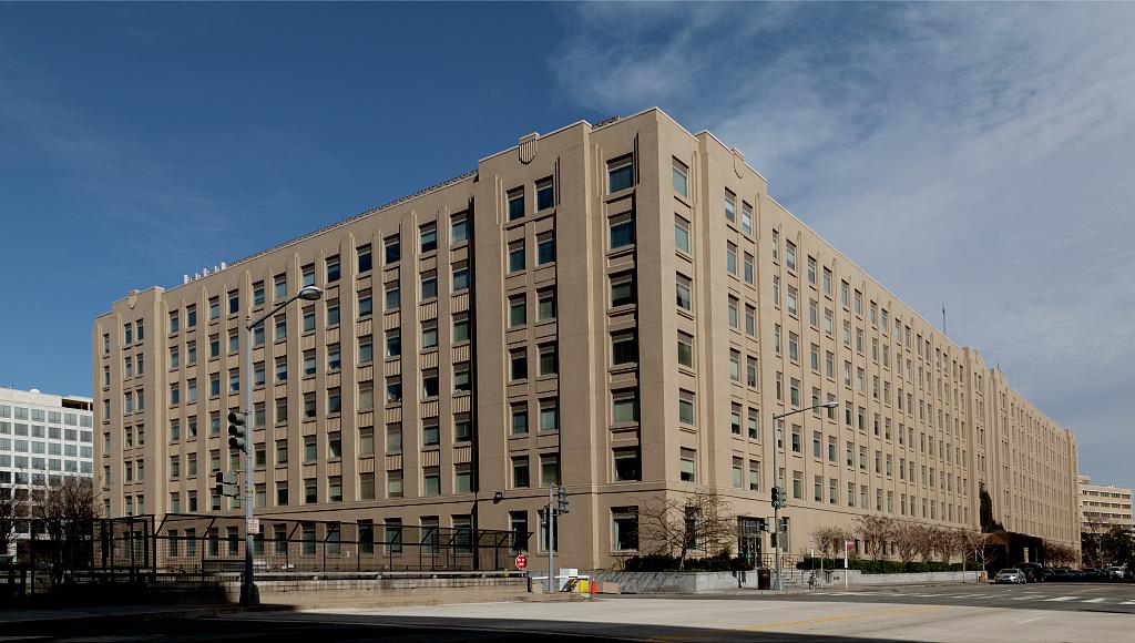 seven-story building on a partly cloudy day