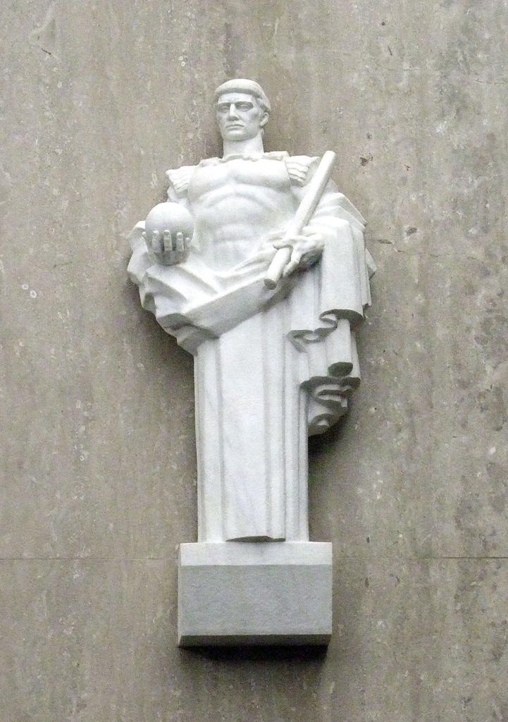 A small white sculpture of a man in ancient Roman style and attire, holding a scroll and a sphere