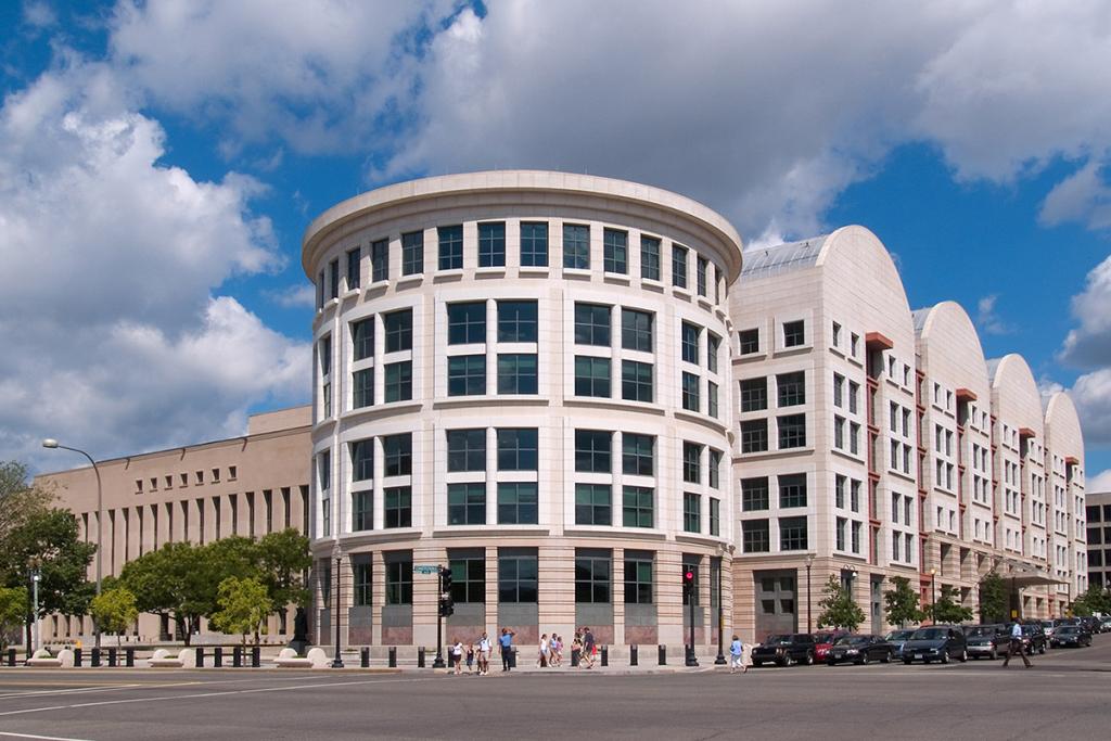 The Bryant Annex, a four-level round, white or light color building with windows next to other buildings