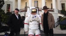 Mythbuster's Adam Savage and Jamie Hyneman posing next to an astronaut space suit.