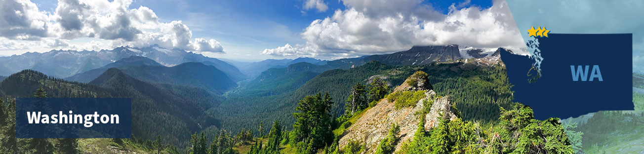 A valley between mountains covered in green pine trees, turning to blue in the distance, with a blue sky and white fluffy clouds, and the title Washington at left and at right the state shape with three gold stars near the northwest corner